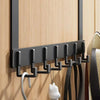 A black heavy duty aluminum door hook rack mounted on a wooden wall, with several hooks for hanging items.