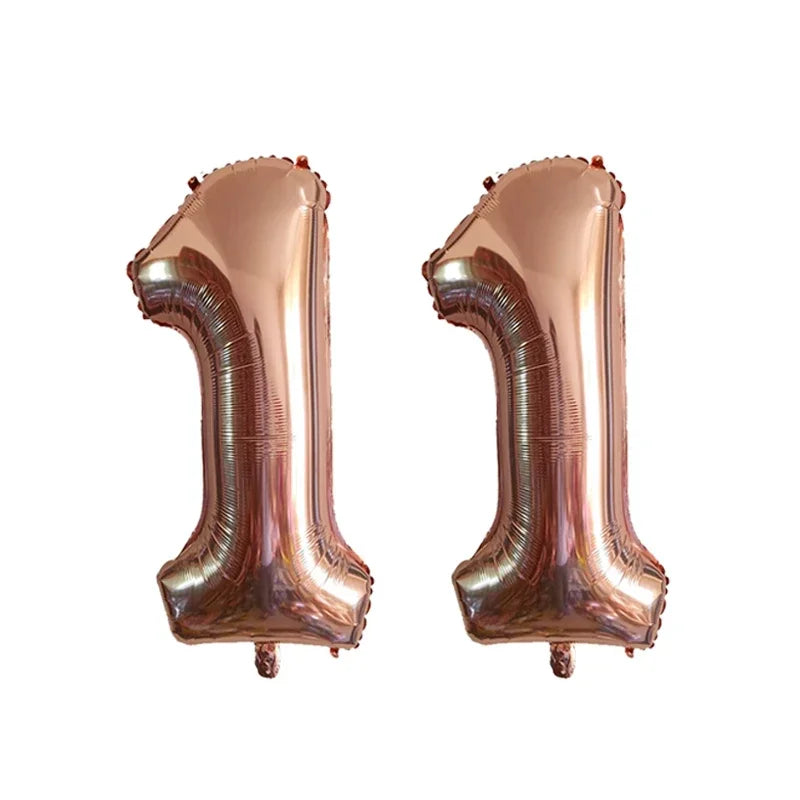 Two metallic rose gold foil number balloons shaped like the number 1.