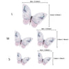 Three butterfly cake toppers in light pink and white colors shown side by side.