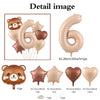 A set of foil balloons shaped like the number six and a bear, in shades of caramel and nude.