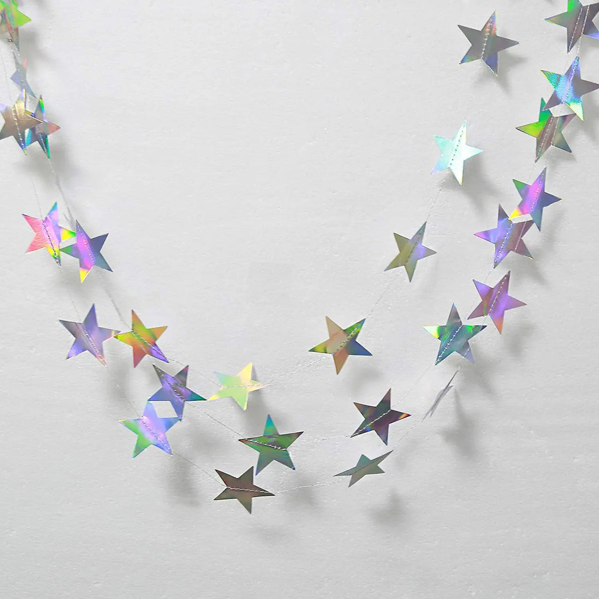 A string of shimmering star paper garland featuring metallic gold and silver stars.