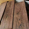 Close-up view of dark brown wood blanks with prominent grain patterns for knife handles and DIY projects