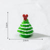 A small, green, conical Christmas tree charm with white stripes and a red heart topper.