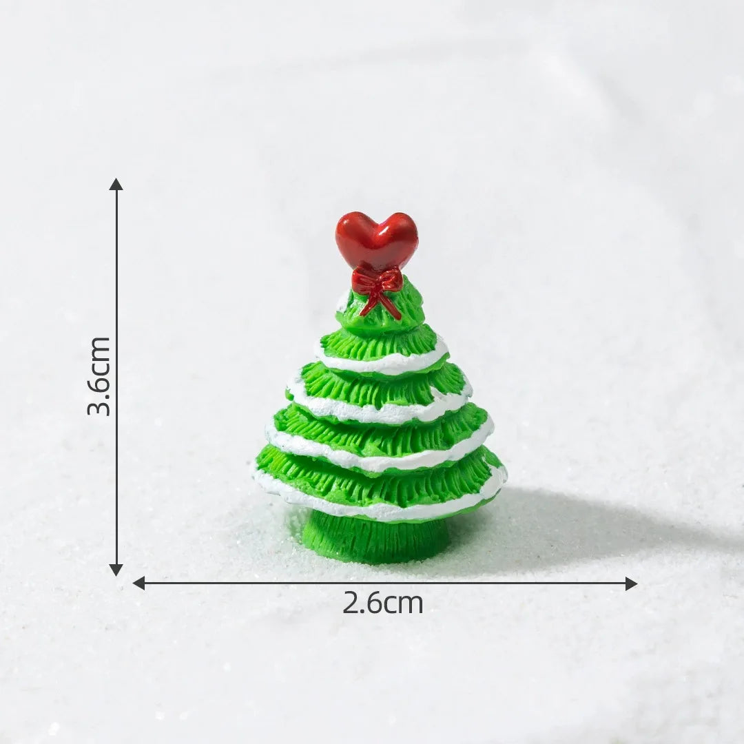 A small, green, conical Christmas tree charm with white stripes and a red heart topper.
