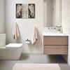 Farmhouse wing wooden frame wall art above a bathroom vanity and toilet.