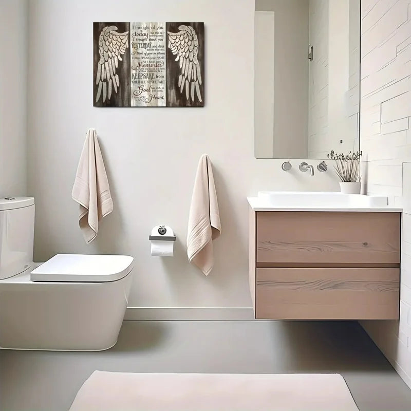 Farmhouse wing wooden frame wall art above a bathroom vanity and toilet.