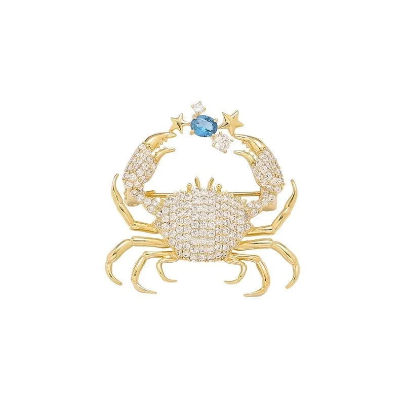 Gold vintage marine life brooch pin set featuring a crab and stars with blue gemstones