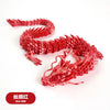 A detailed red dragon ornament made of resin, featuring scales and a serpentine body.