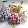 A bouquet of artificial pink peony silk flowers in various shades of pink and cream.