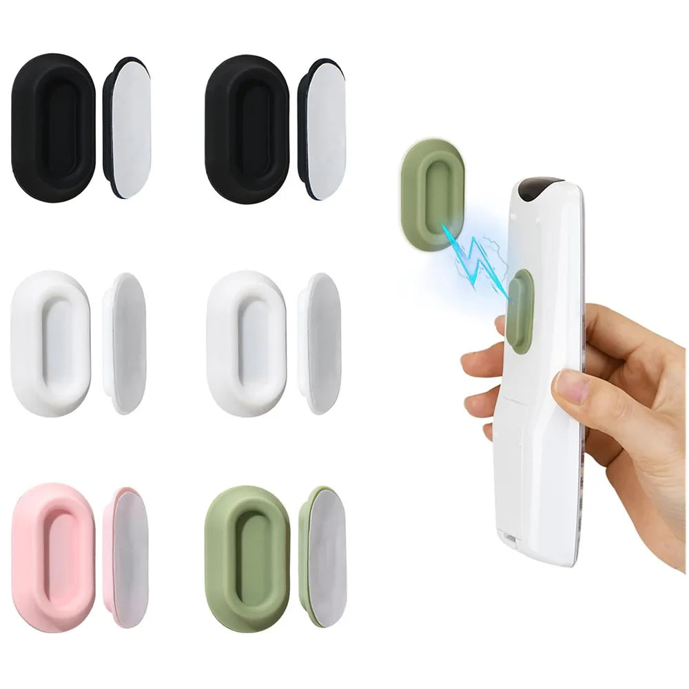A set of magnetic silicone remote control holders in black, white, and light green colors shown alongside a hand holding a wh