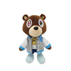 A brown bear plush toy with large eyes and a light blue jacket.