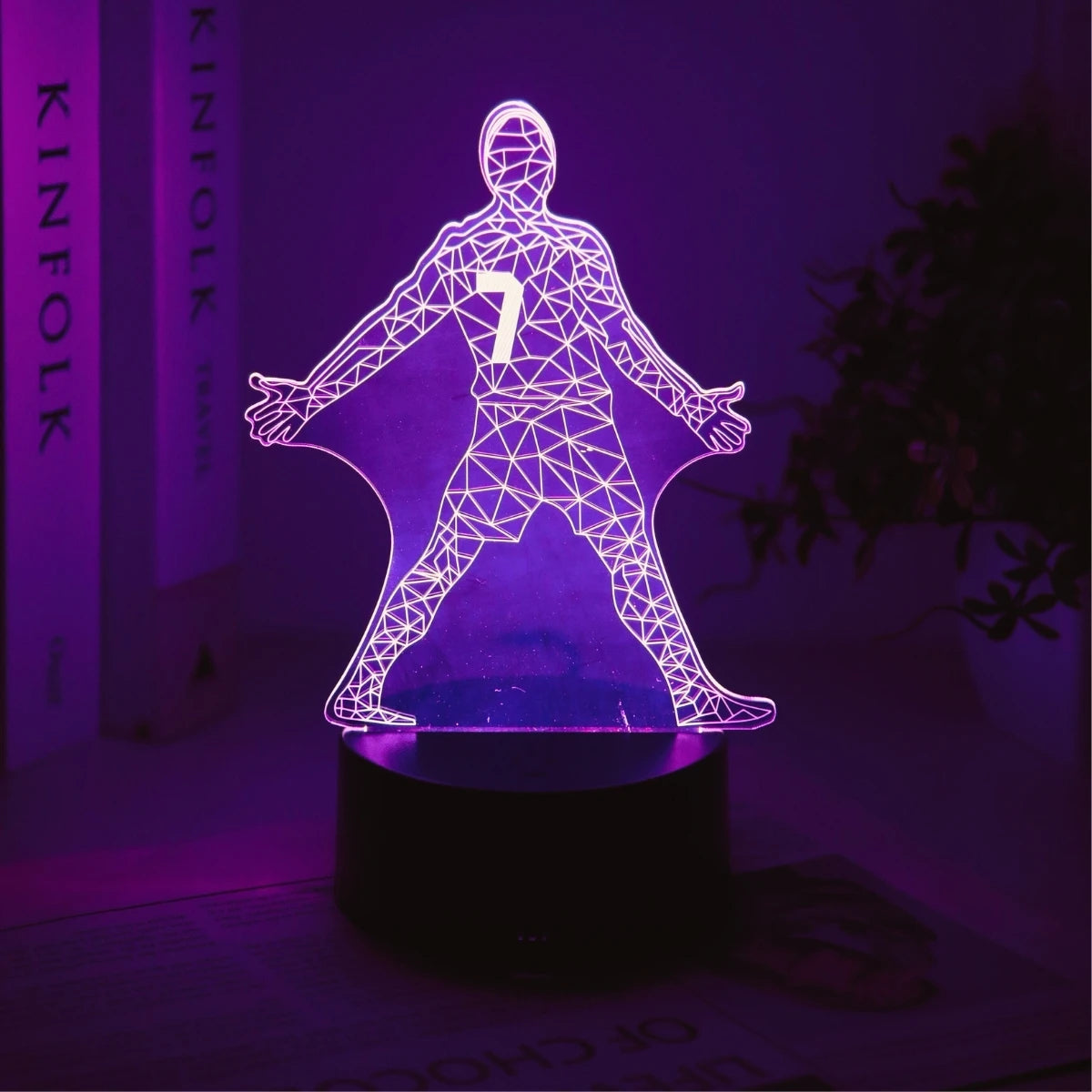 A glowing outline of a football player with the number 7 stands on a dark surface.
