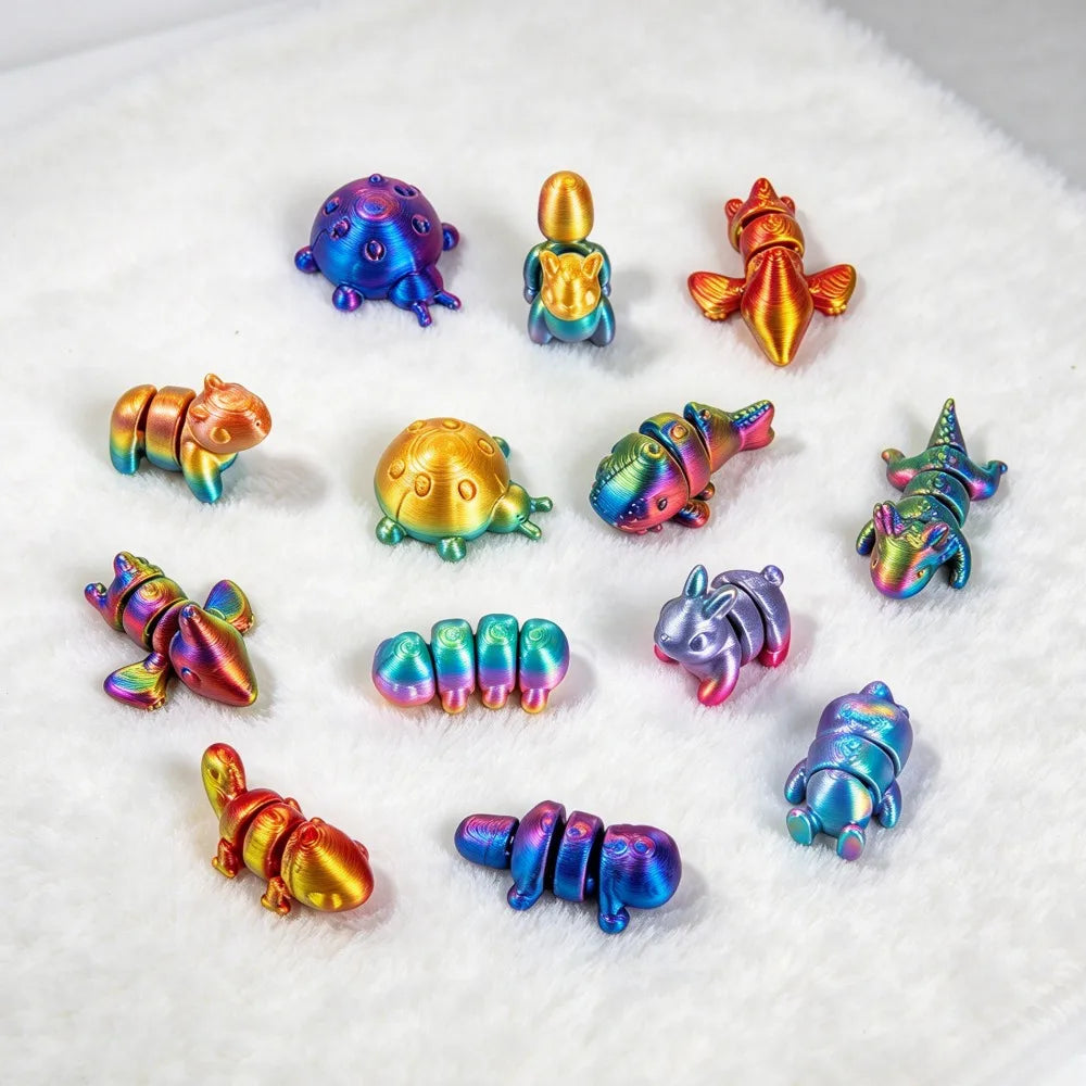 A collection of colorful, 3D printed articulated animal figurines in various poses and colors resting on white fluffy materia