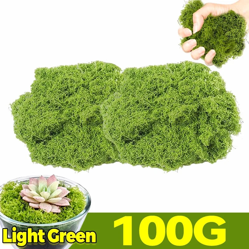 A hand holds a clump of light green artificial moss, with a bowl of the same moss visible below.