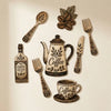 A vintage wooden coffee utensil set featuring a teapot, spoon, fork, and other serving pieces on a light background.