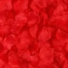 Close-up of vibrant red simulation silk rose petals used for event decor.
