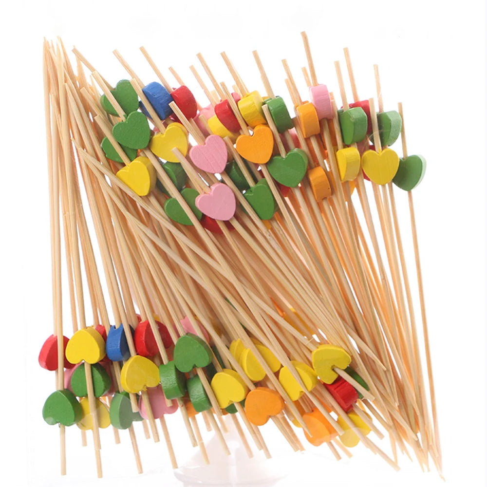 A bundle of pearl-tipped bamboo cocktail picks in various colors like green, yellow, pink, and red.