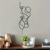 Minimalist abstract face metal wall art featuring continuous line drawings of a profile