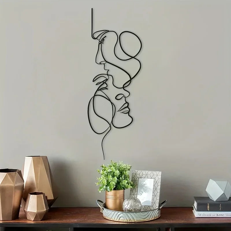 Minimalist abstract face metal wall art featuring continuous line drawings of a profile