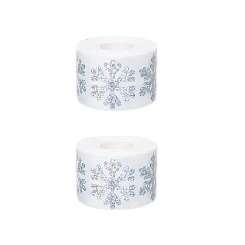 Roll of glittery laser Christmas snowflake stickers on a white background