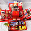 A red gift box filled with various snacks and candies is displayed on a white surface.