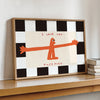 A framed wall art print featuring an orange silhouette of a bird saying I love you this much on a black and white checkered b