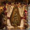 An elegant wedding backdrop featuring a large Christmas tree decorated with string lights and red floral garlands.