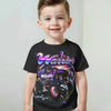 A young boy wearing a black t-shirt with a full graphic print of a Warrior Monster Jam Grave Digger theme.