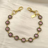 Gold chain necklace with pink and gold rhinestone flower charms and a rectangular tag.