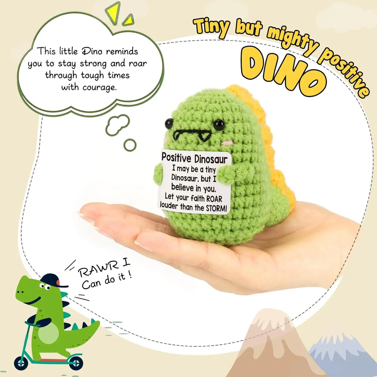 A handmade crochet dinosaur doll is held in a hand with an inspirational message about staying strong and having courage.