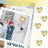 A set of gold heart fridge magnets displayed on a white background with a winter theme.