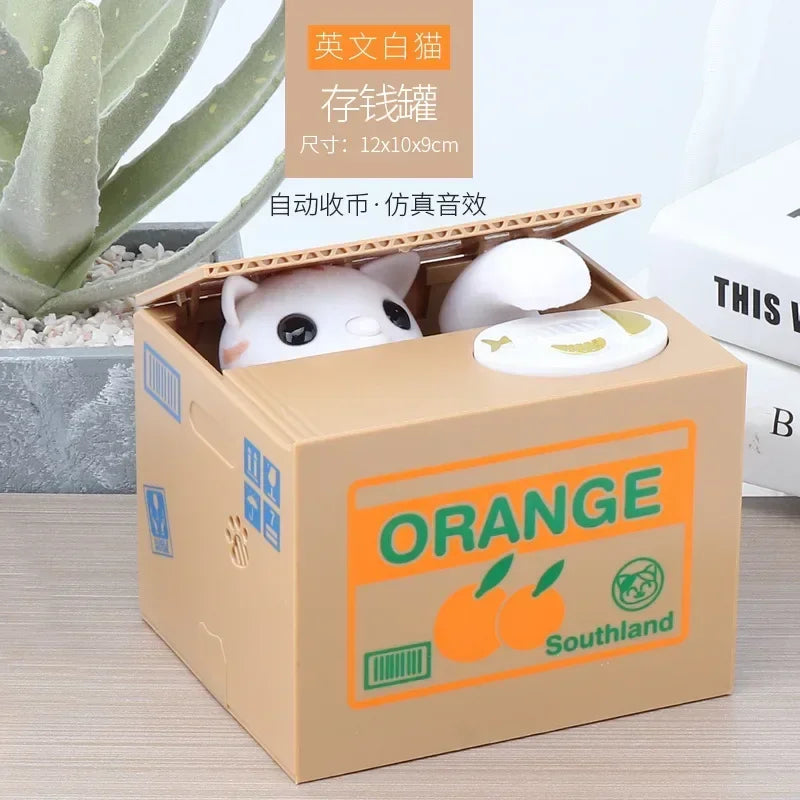 An orange cardboard box containing a white ceramic coin bank shaped like a cute animal for kids.