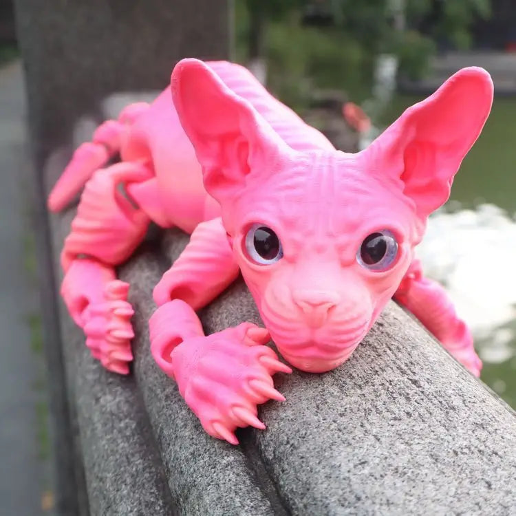 A pink realistic Sphynx cat fidget toy with large ears looking directly at the camera.