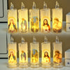 A set of five clear glass candles with LED lights depicting religious figures like the Virgin Mary and Jesus.