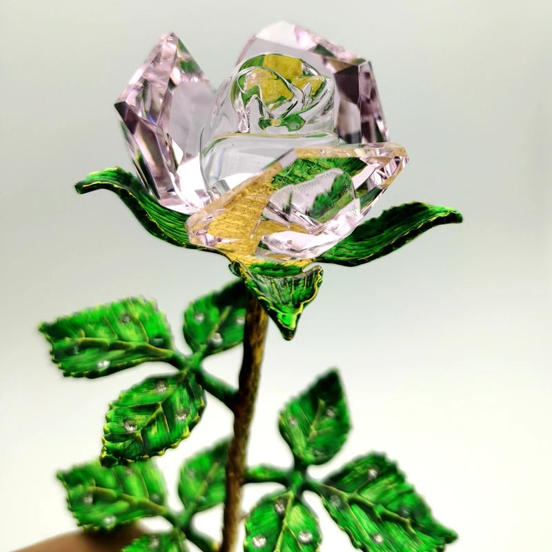 Handcrafted crystal glass rose vase with pink petals and golden leaves on a stem