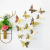 Collection d'autocollants muraux de papillons en or et argent sur fond blanc.