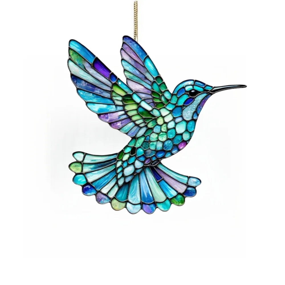 A colorful acrylic hummingbird suncatcher ornament with iridescent blue and green wings hanging by a gold chain.