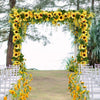 A floral archway decorated with yellow sunflowers and greenery for a wedding ceremony backdrop.