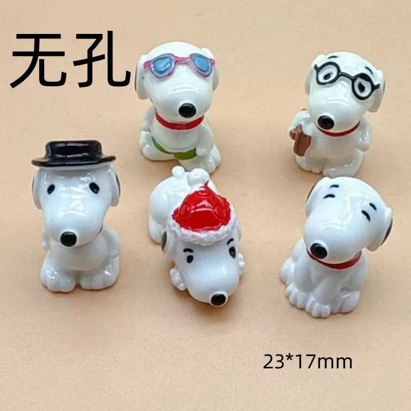 A collection of white ceramic dog pendants, some wearing glasses or hats, used for jewelry making.