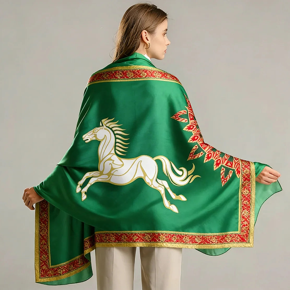 A woman models a green tapestry featuring a white horse design with red and gold borders.