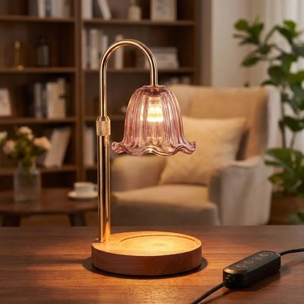 A brass adjustable height aromatherapy candle warmer lamp sitting on a wooden table.