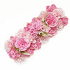 A cluster of pink and light pink artificial silk rose flowers arranged in a decorative panel.