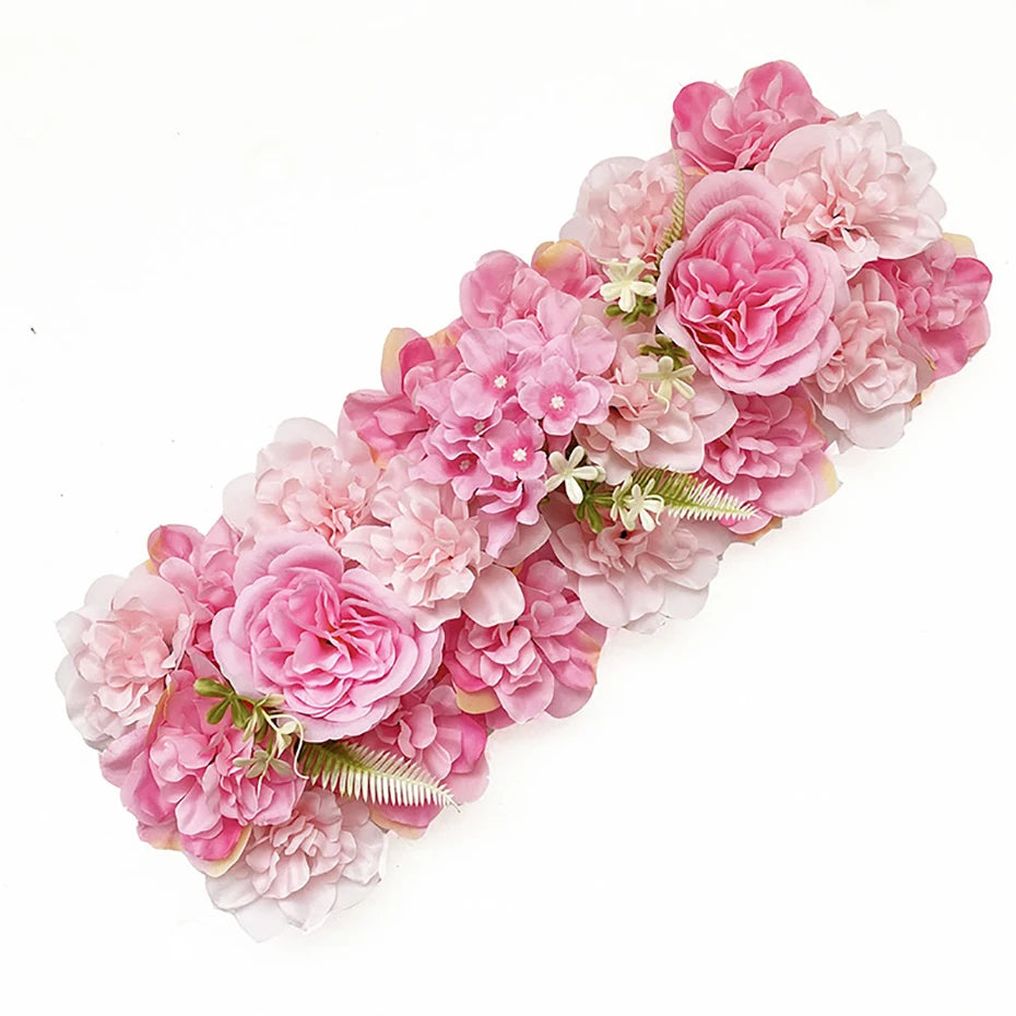 A cluster of pink and light pink artificial silk rose flowers arranged in a decorative panel.