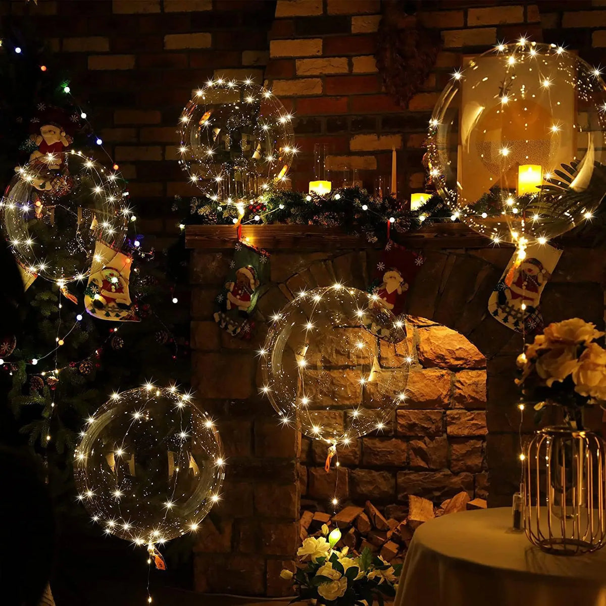 A display of LED light-up balloons with warm glow string lights arranged on a brick fireplace mantel.