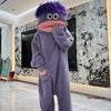 A purple coral fleece hooded sleepsuit resembling a monster with large eyes and a pink mouth.