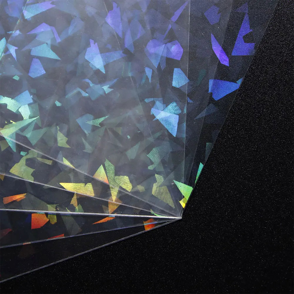 A close-up view of holographic card sleeves showing iridescent colors and light refraction.