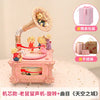 Pink retro carousel music box decoration featuring a golden horn and a small figurine.