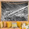 A black and white manga art tapestry featuring a fierce warrior in motion, displayed as bedroom decor.