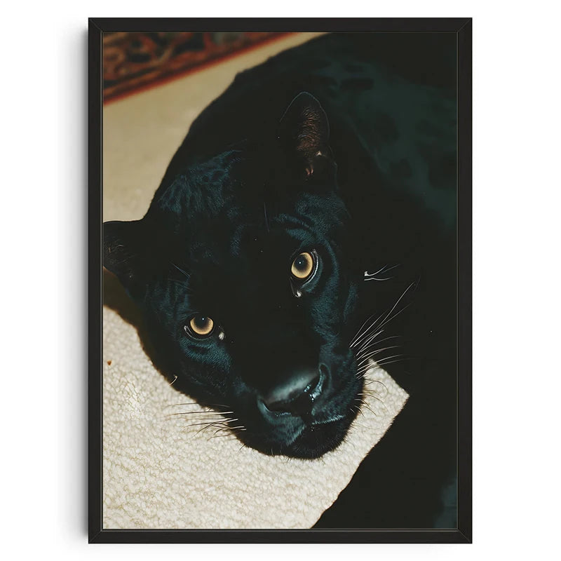 A close-up portrait of a black cat with golden eyes looking directly at the viewer.