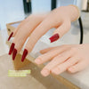 A hand model with realistic joints and red nails used for manicure training display.
